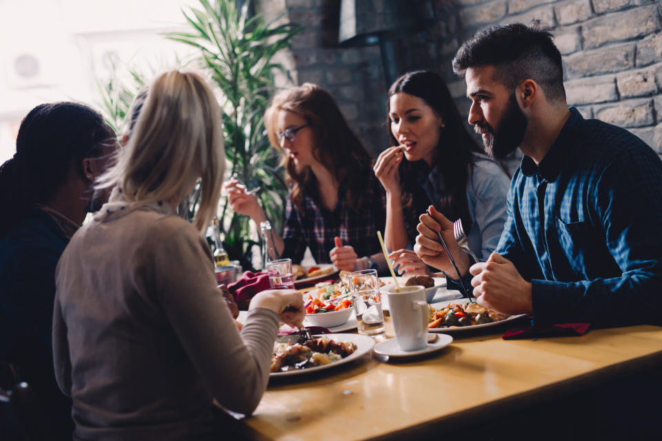 A group of people eating together at a restaurant