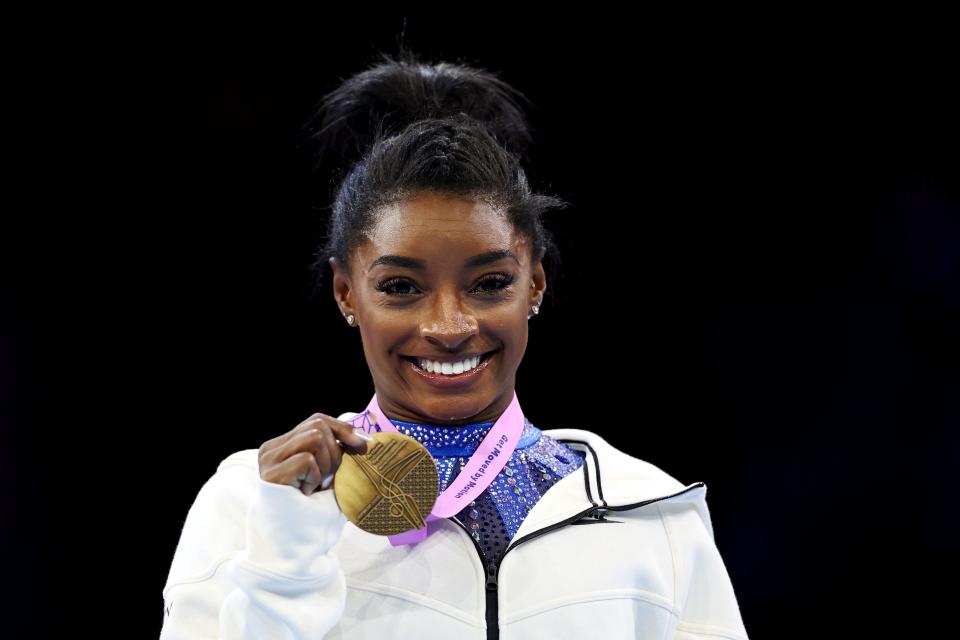 Simone Biles poses with her gold medal after winning the all-around world championship on Friday in Antwerp, Belgium.