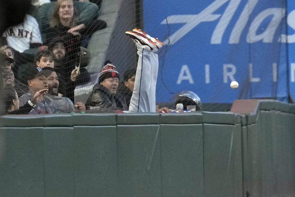 Fans react as Tampa Bay Rays left fielder Randy Arozarena cannot catch a fly ball in foul territory hit by San Francisco Giants' Michael Conforto during the fifth inning of a baseball game in San Francisco, Tuesday, Aug. 15, 2023. (AP Photo/Jeff Chiu)