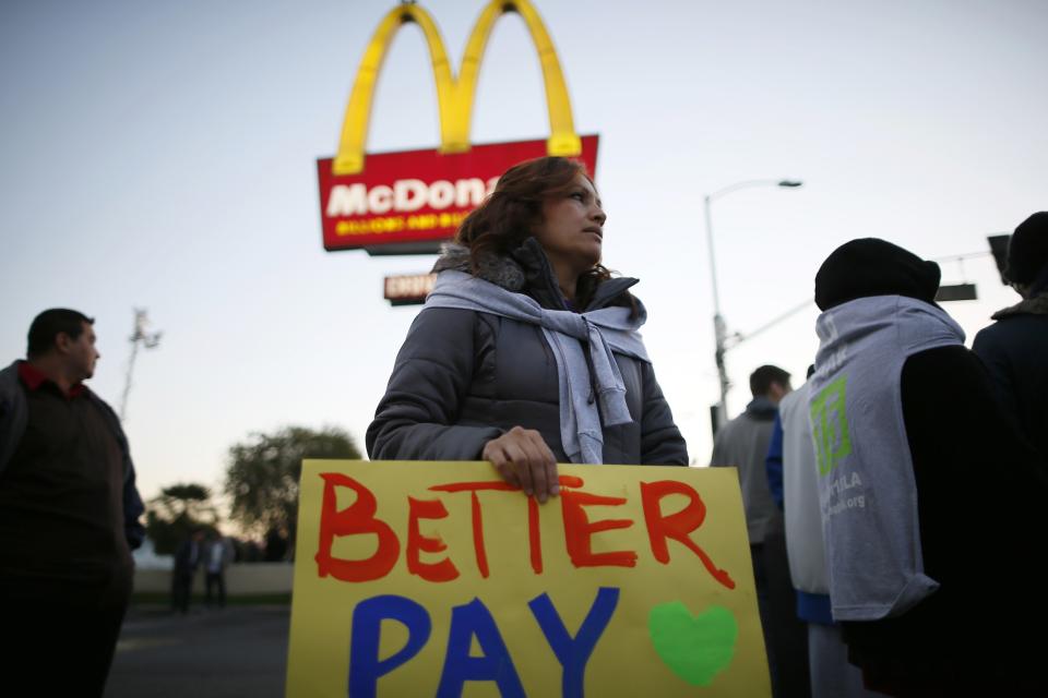 Protesters march outside McDonald's in Los Angeles, California, December 5, 2013. Organizers say fast food workers will strike in 100 U.S. cities, and there will be protests in 100 more, to fight for $15 an hour wages and the right to form a union. (REUTERS/Lucy Nicholson)