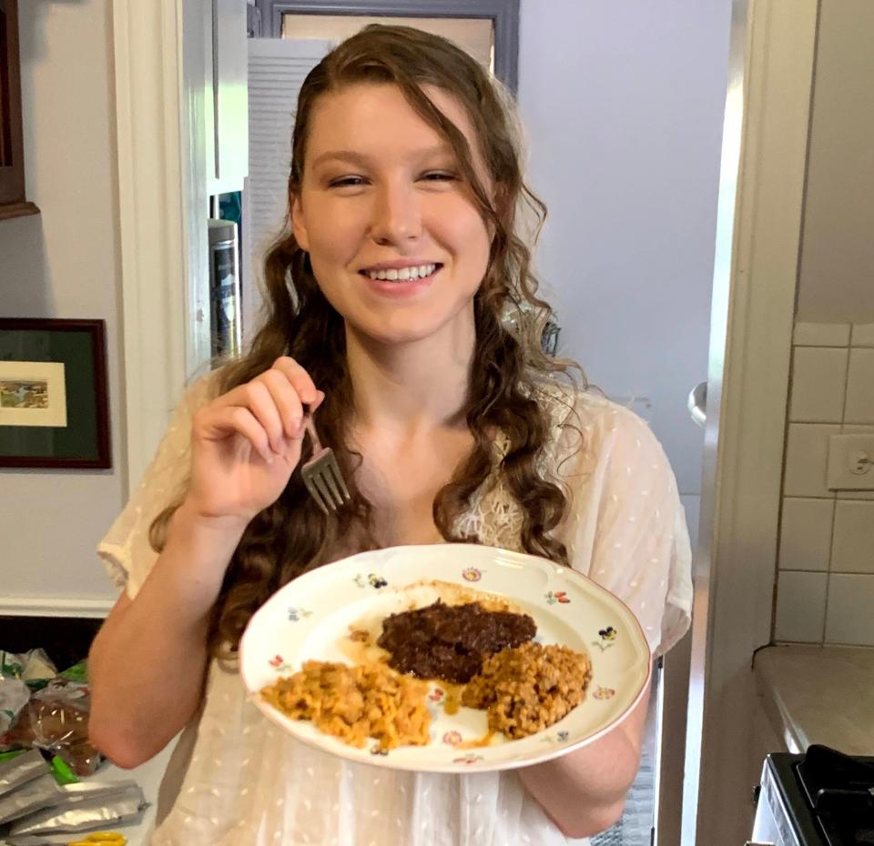 smiling woman with plate of food