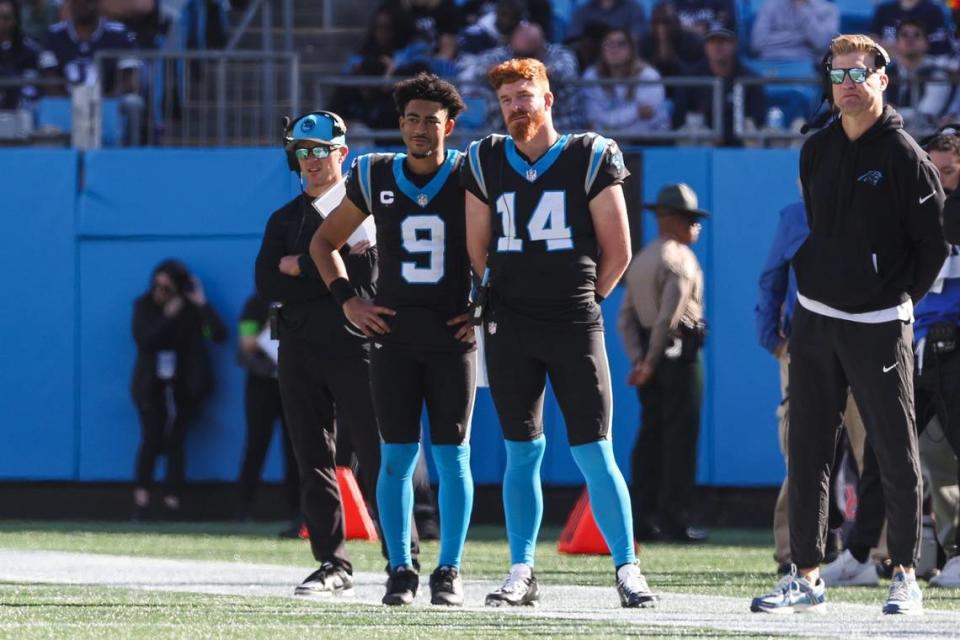 Panthers quarterbacks Bryce Young (9) and Andy Dalton (14) watch the game against the Cowboys from the sideline at Bank of America Stadium on Sunday, November 19, 2023 in Charlote, NC.