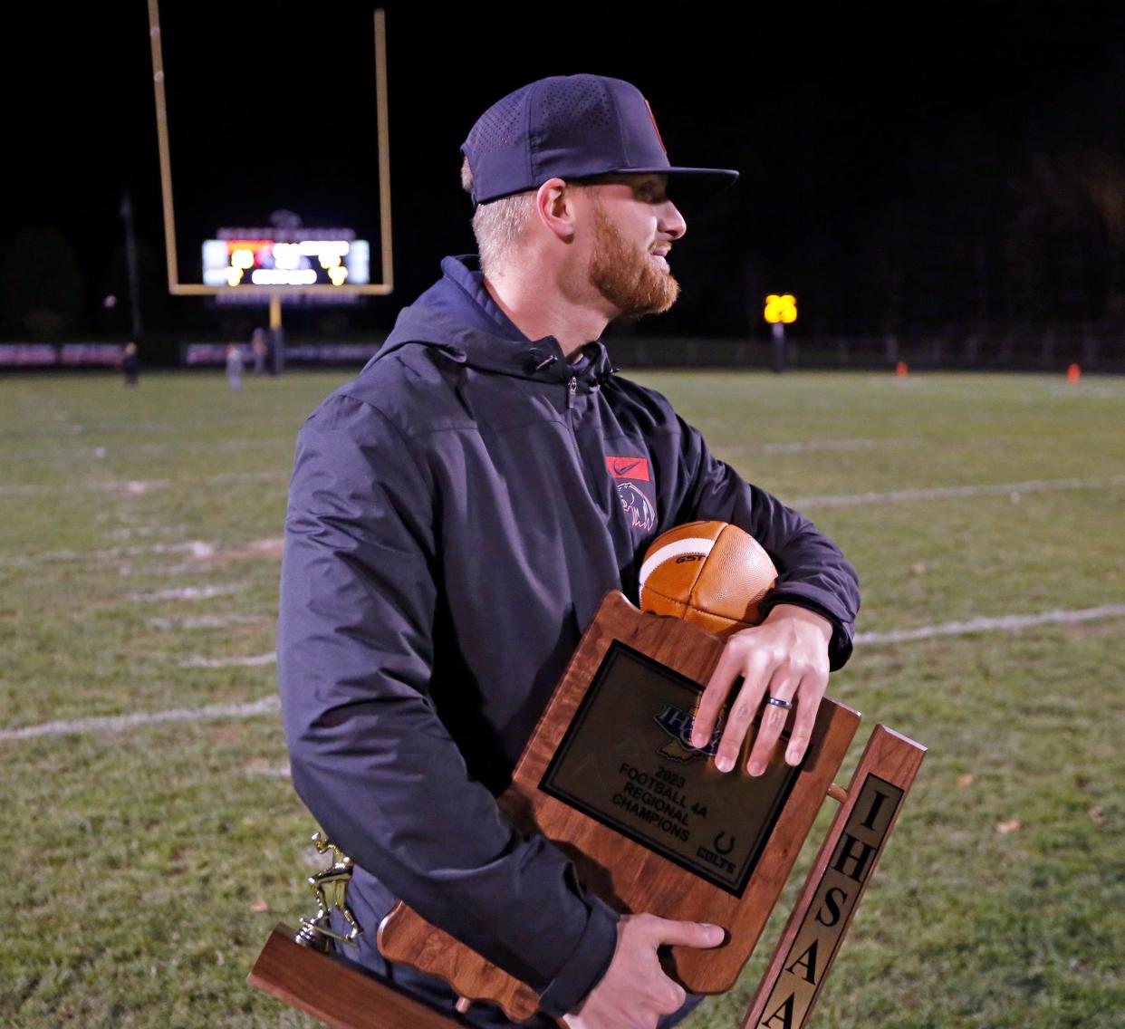 Then-NorthWood Athletic Director Roman Smith holds the Class 4A football regional championship trophy after the Panthers beat New Prairie Friday, Nov. 10, 2023, at NorthWood High School in Nappanee. Smith will be stepping down from the role at the end of March.