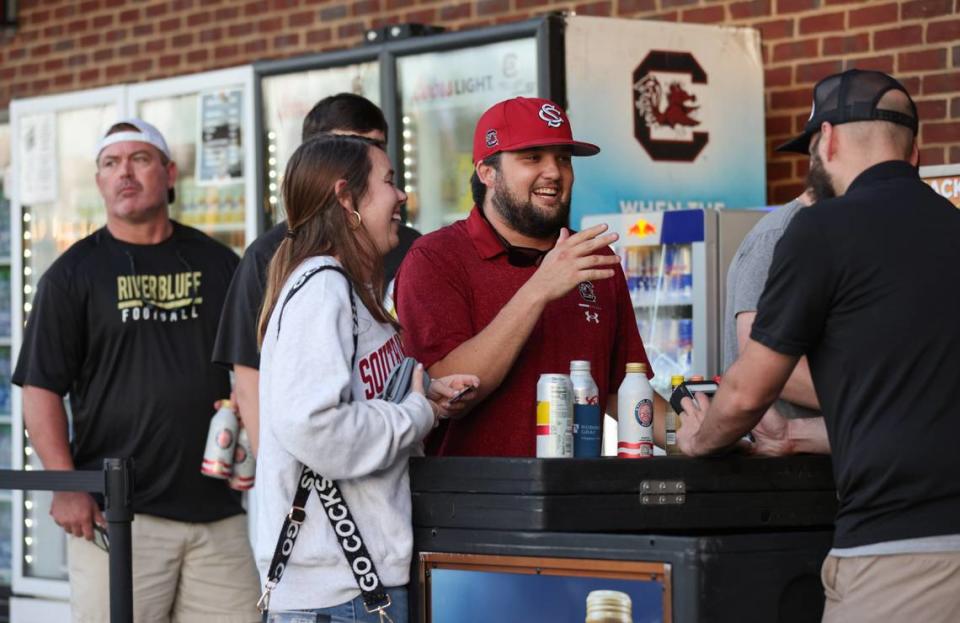 Jack Moorman and Haley Saxby purchase beers before the Gamecocks’ game against Georgia at Founders Park in Columbia on Thursday, May 9, 2024.