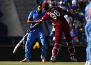 India's bowler Ravichandran Ashwin (L) collides with West Indies captain Jason Holder during their Cricket World Cup match in Perth, March 6, 2015. REUTERS/David Gray