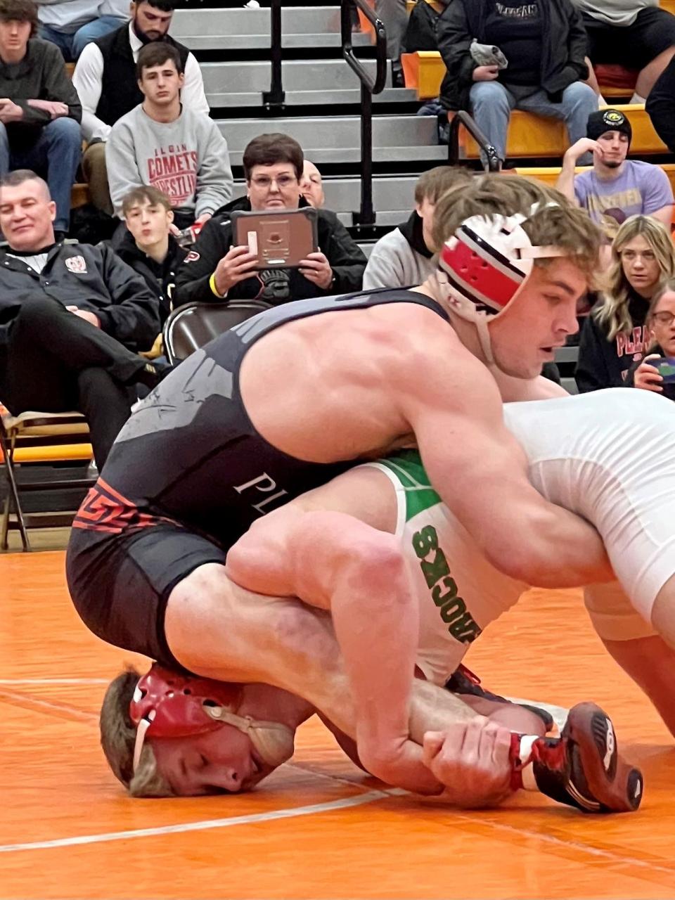 Pleasant's Daxton Chase ties up Barnesville's Reese Stephen in the 150-pound title match at the Division III boys wrestling district tournament at Heath.