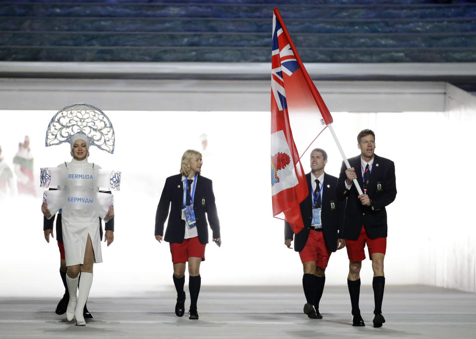 Tucker Murphy of Bermuda carries the national flag as he leads the team during the opening ceremony of the 2014 Winter Olympics in Sochi, Russia, Friday, Feb. 7, 2014. (AP Photo/Mark Humphrey)