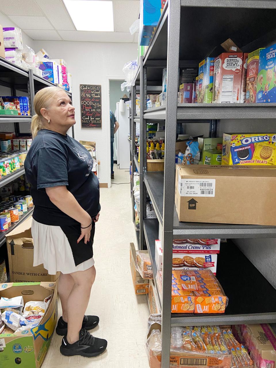 Delisa Jones, owner and founder of Second Chances Thrift Store ministry, looks for an item in the food pantry in the ministry's Oklahoma City store at 2605 N MacArthur Blvd.
