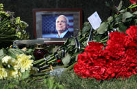 <p>Flowers lay at the portrait of late United States Senator John McCain outside the Embassy of the United States in Kiev, capital of Ukraine, Aug. 27, 2018. (Photo: Danil Shamkin / Barcroft Media via Getty Images) </p>