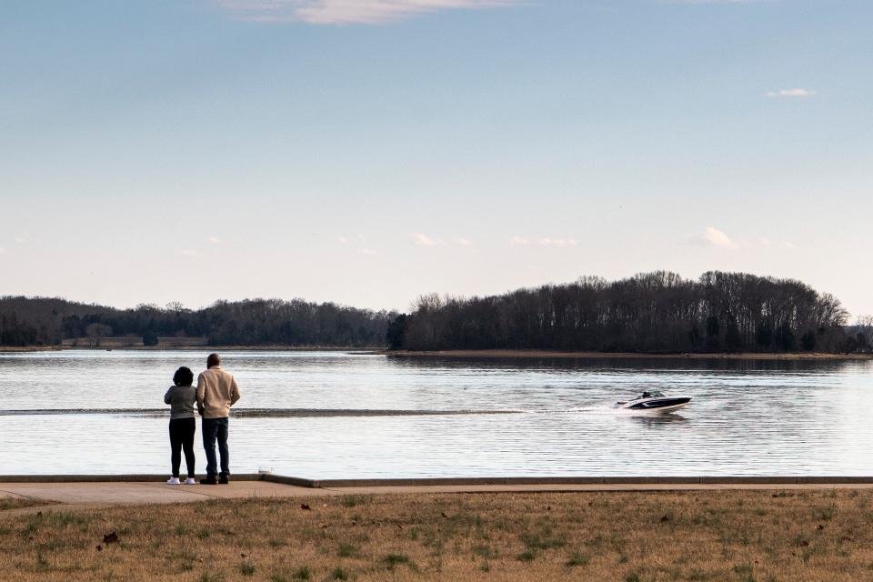 People take in the view as a boat passes by at Percy Priest Lake in Nashville, Tenn., Saturday, Feb. 2, 2019. The temperature reached the low 60s on Saturday afternoon. 