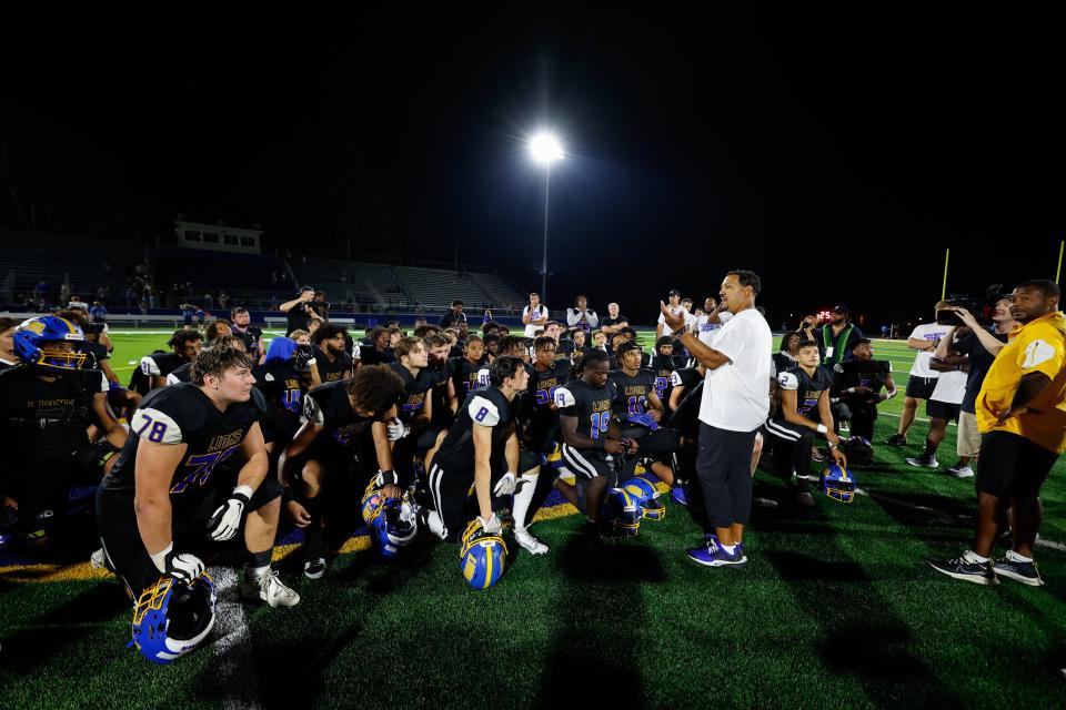 Gahanna Lincoln coach Bruce Ward talks to his players after the Lions' win against Olentangy Liberty on Friday night.