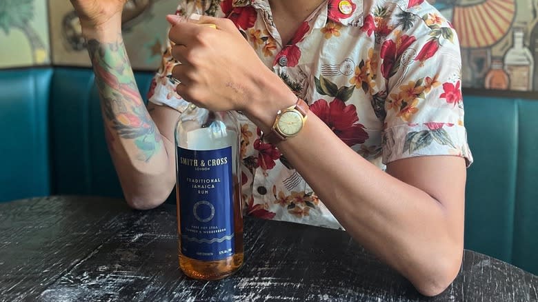 person holding smith cross rum 