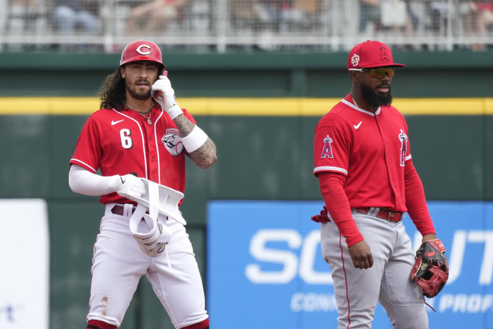 Cincinnati Reds' Jonathan India (6) stands at second base next to Los Angeles Angels second baseman Luis Rengifo after advancing on his run-scoring single during the fourth inning of a spring training baseball game Monday, March 20, 2023, in Goodyear, Ariz. (AP Photo/Ross D. Franklin)