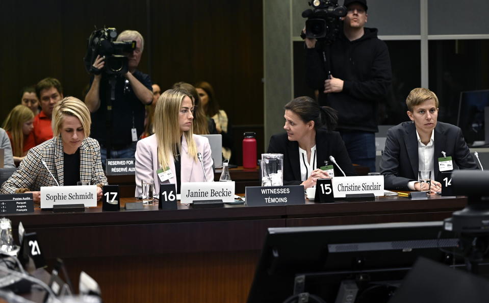 Canadian national soccer team players Sophie Schmidt, left, Janine Beckie, Christine Sinclair, and Quinn, right, prepare to appear before the Standing Committee on Canadian Heritage in Ottawa, studying safe sport in Canada, Thursday, March 9, 2023. (Justin Tang/The Canadian Press via AP)