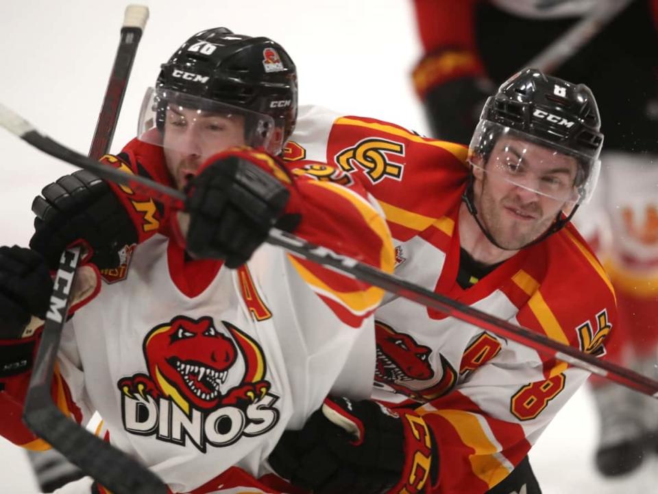 Bradley Schoonbaert, left, and Connor Gutenberg react after Schoonbaert scored in the third period of Game 2 of the Canada West men's hockey final against the Alberta Golden Bears at Father David Bauer Arena in Calgary on March 4. The two Brandonites are among five Manitobans on the Dinos squad. (David Moll/Calgary Dinos - image credit)