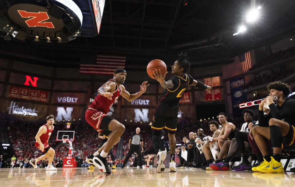 Minnesota's Elijah Hawkins, right, leans back to field an errant pass as Nebraska's Jamarques Lawrence defends during the second half of an NCAA college basketball game, Sunday, Feb. 25, 2024, in Lincoln, Neb. (AP Photo/Rebecca S. Gratz)