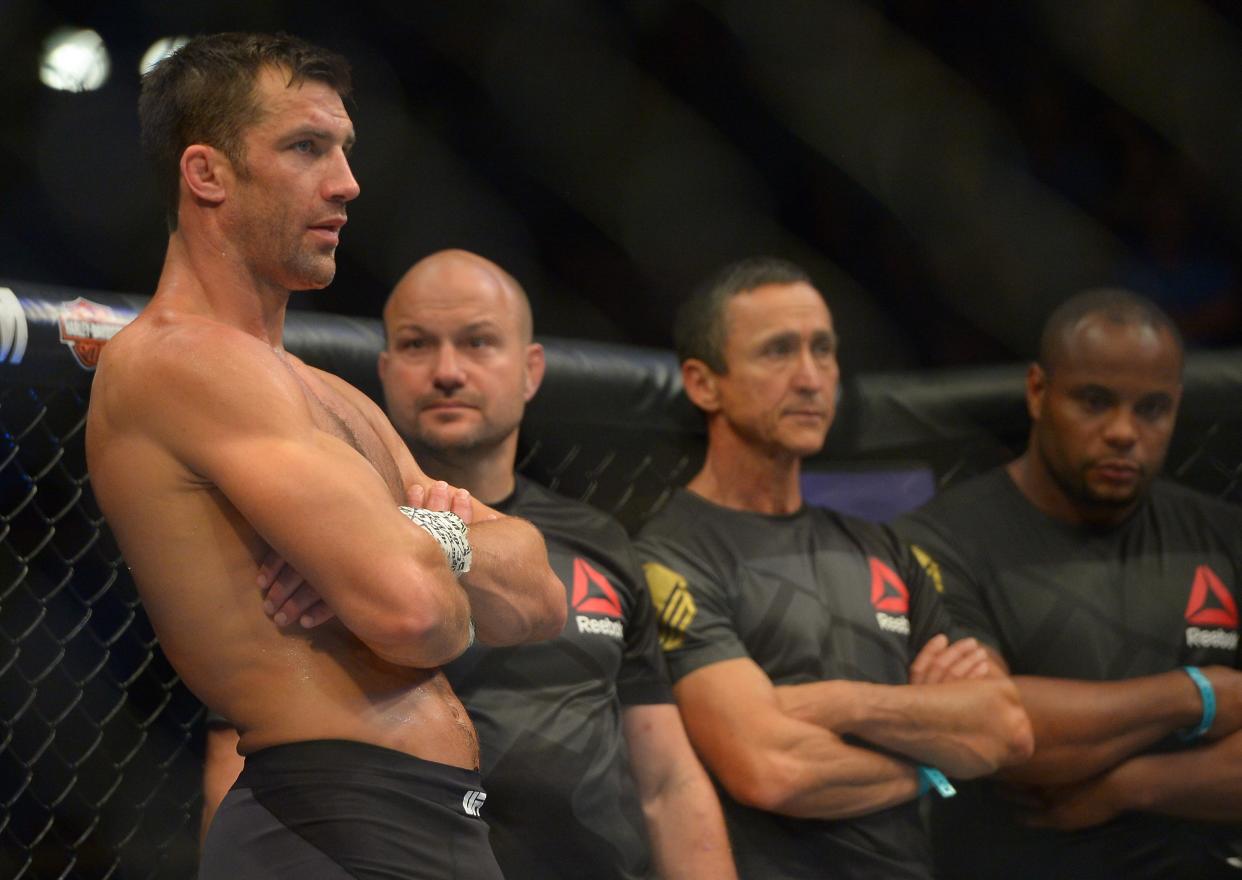 Luke Rockhold (L) stands in the cage after he was defeated by Michael Bisping at UFC 199. (Getty)