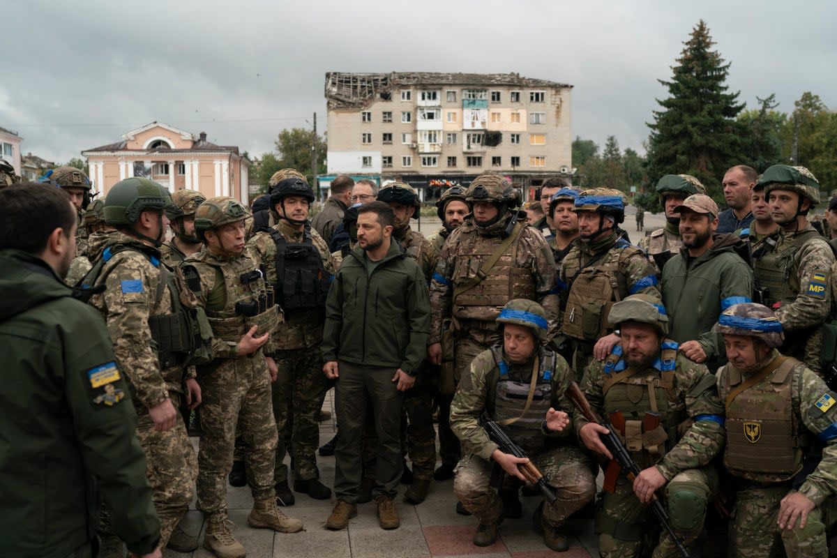 Ukrainian President Volodymyr Zelenskyy stands with soldiers after attending a national flag-raising ceremony in the freed Izium (Copyright 2022 The Associated Press. All rights reserved.)