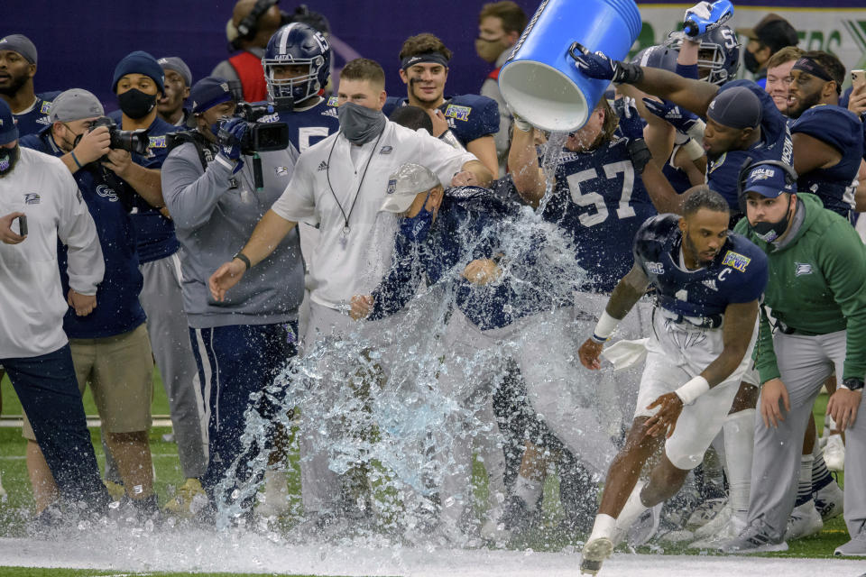 Georgia Southern head coach Chad Lunsford gets doused as his team starts to celebrate a victory over Louisiana Tech in the New Orleans Bowl NCAA college football game in New Orleans, Wednesday, Dec. 23, 2020. (AP Photo/Matthew Hinton)