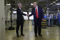 Apple CEO Tim Cook and President Donald Trump shake hands during a tour of an Apple manufacturing plant, Wednesday, Nov. 20, 2019, in Austin. (AP Photo/ Evan Vucci)