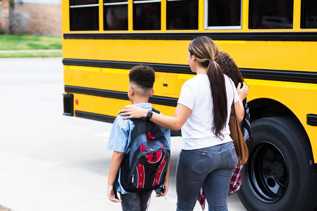 <p>Getty</p> Stock image of mom taking kids to school