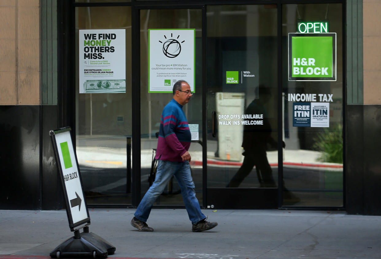 A pedestrian walks past a H&R Block tax office in Los Angeles, California, U.S., April 26, 2017.  REUTERS/Mike Blake