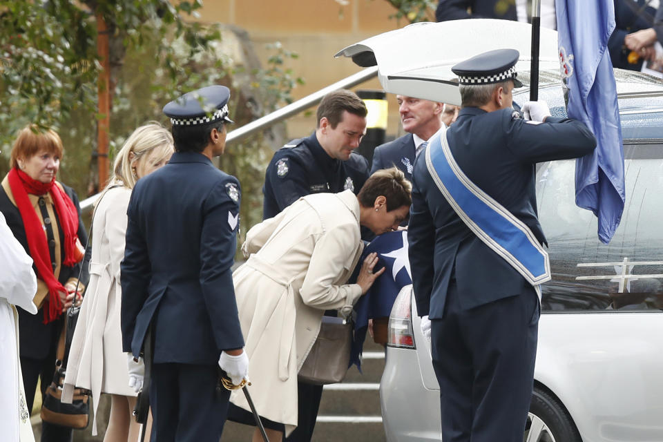 Mourners pay their respects as the coffin is placed inside the hearse during the funeral of Constable Josh Prestney at Xavier College. Source: AAP