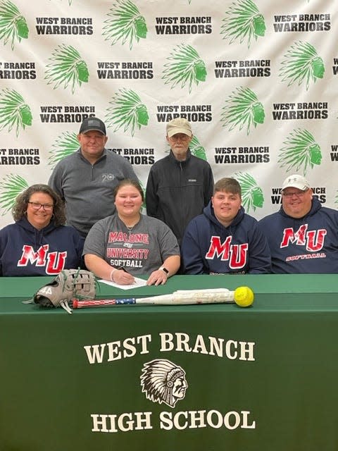 Zoe Lesch of West Branch will attend Malone University to continue her softball career. She is joined at her signing ceremony by parents Anna, front left, and Michael, far front right; brother Michael, center right, and coaches Jeremy Hunter and Bob Hoiles.