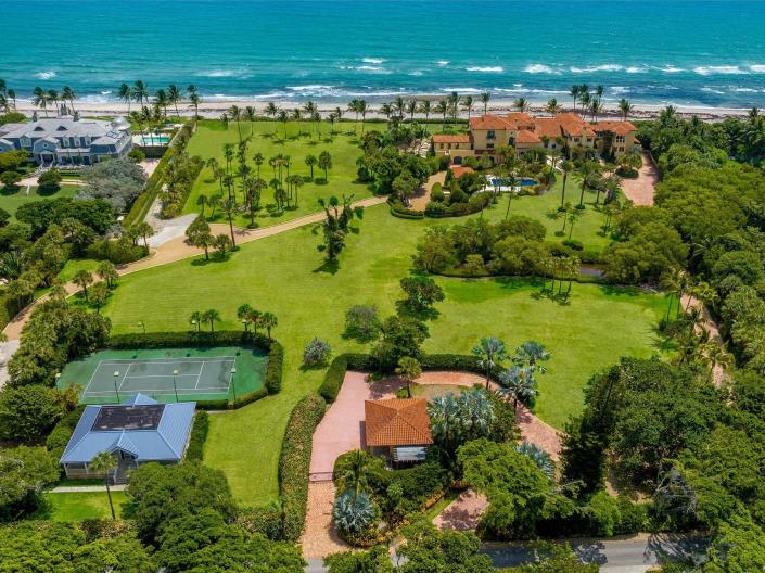 Aerial view of Florida estate belonging to Larry Ellison with mansion, tennis court, pool, ocean in view
