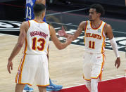 Atlanta Hawks guard Trae Young (11) celebrates a score with teammate guard Bogdan Bogdanovic (13) in the second half of an NBA basketball game against the Orlando Magic Thursday, May 13, 2021 in Atlanta. (AP Photo/Tami Chappel)