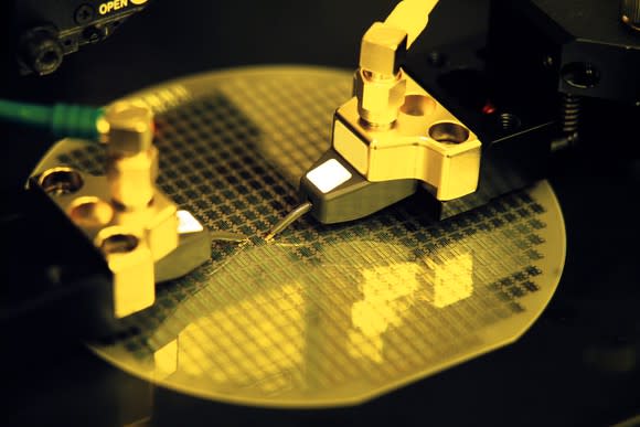 Chip manufacturing tools hard at work on an uncut wafer of semiconductor silicon.