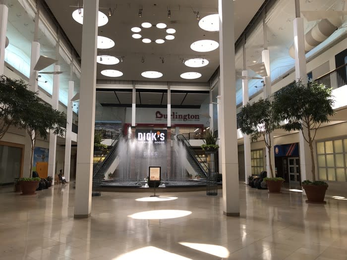 Soon-to-open Burlington and Dick's Sporting Goods stores behind a fountain at Plymouth Meeting Mall