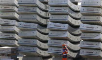 Parts of the tunnel being built on the Turin-Lyon high-speed rail link (TAV) are piled up in Saint Martin La Porte, France, Tuesday, Feb. 12, 2019. The TAV project is part of a European wide network to improve high-speed rail connections. On the Italian side, the construction site long targeted by sabotaging protesters is guarded by four law enforcement agencies and has been reduced to maintenance work only. The survival of Italy's increasingly uneasy populist government could very well depend on whether Italy restarts construction on the TAV link, which it halted in June. (AP Photo/Antonio Calanni)