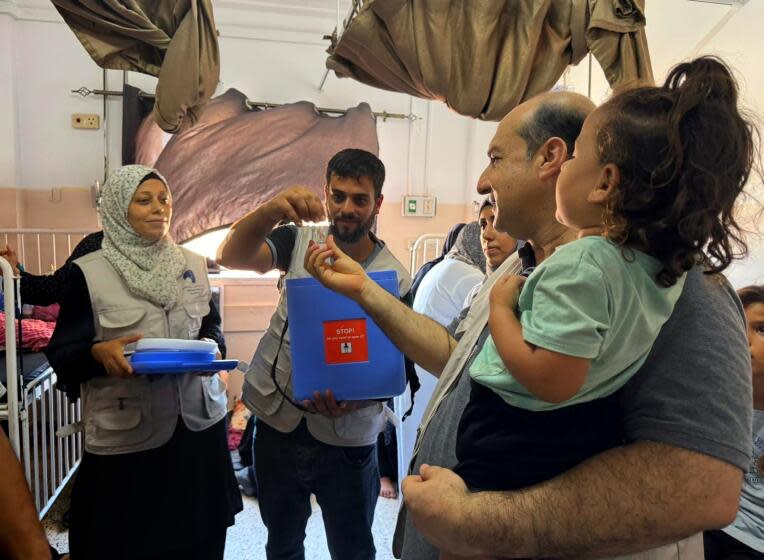 GAZA, ISRAEL-Sept. 9, 2024-A polio vaccine campaign is underway in Gaza. Medical staff and parents at a vaccination site in Khan Younis. (Bilal Shbair / For the Times)