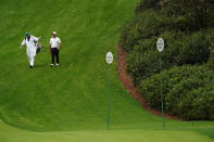 Francesco Molinari, of Italy, walks with a caddie down the sixth fairway during the first round of the Masters golf tournament Friday, Nov. 13, 2020, in Augusta, Ga. (AP Photo/Charlie Riedel)