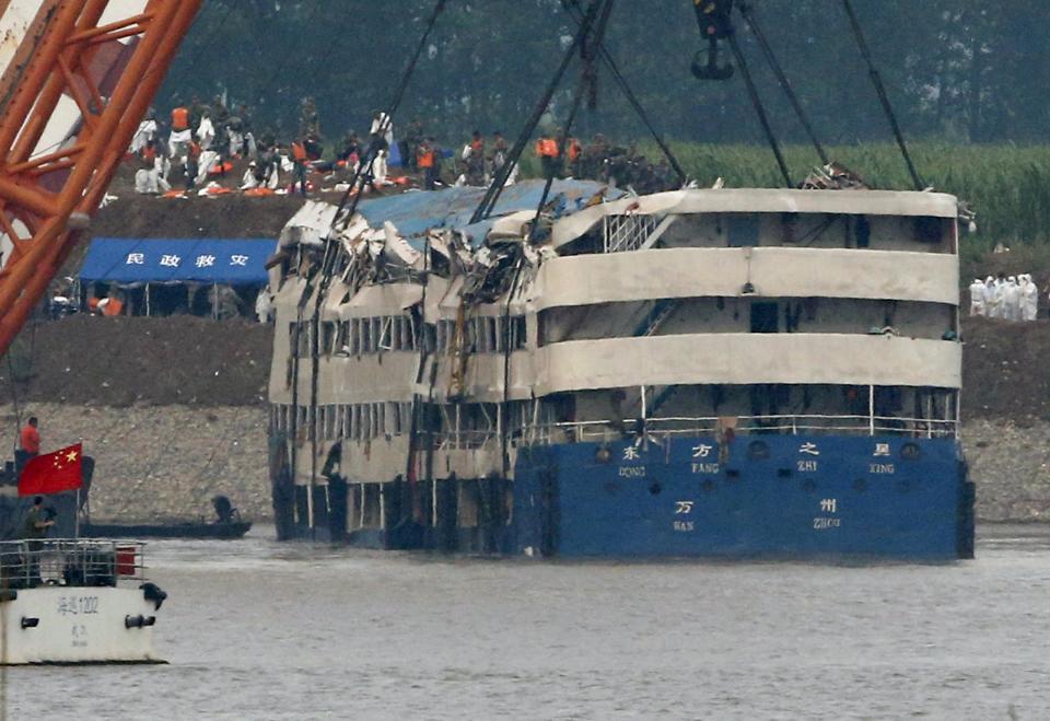 A rescue team works on lifting the capsized cruise ship Eastern Star in the Jianli section of Yangtze River, Hubei province