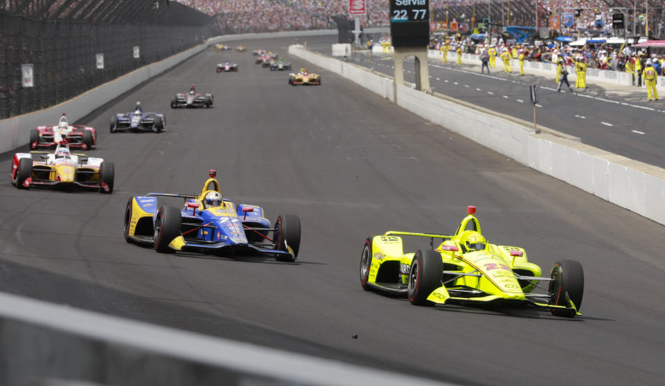 Simon Pagenaud, of France, leads Alexander Rossi and Takuma Sato, of Japan, into the first turn in the closing laps Indianapolis 500 IndyCar auto race at Indianapolis Motor Speedway, Sunday, May 26, 2019, in Indianapolis. Pagenaud has won his first Indy 500, making an audacious pass of Rossi before taking the white flag and holding of the hard-charging driver from Andretti Autosport. (AP Photo/R Brent Smith)