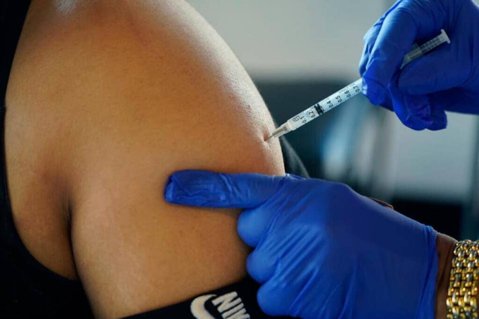 A Jackson, Miss., resident receives a Pfizer booster shot from a nurse at a vaccination site Feb. 8, 2022. Pfizer is asking the Food and Drug Administration to expand use of its updated COVID-19 booster shot to children ages 5 to 11, Monday, Sept. 26. (AP Photo/Rogelio V. Solis, File)