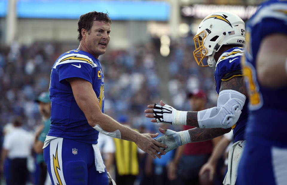 Los Angeles Chargers quarterback Philip Rivers, left, celebrates after throwing a touchdown pass against the Arizona Cardinals during the first half of an NFL football game Sunday, Nov. 25, 2018, in Carson, Calif. (AP Photo/Kelvin Kuo)
