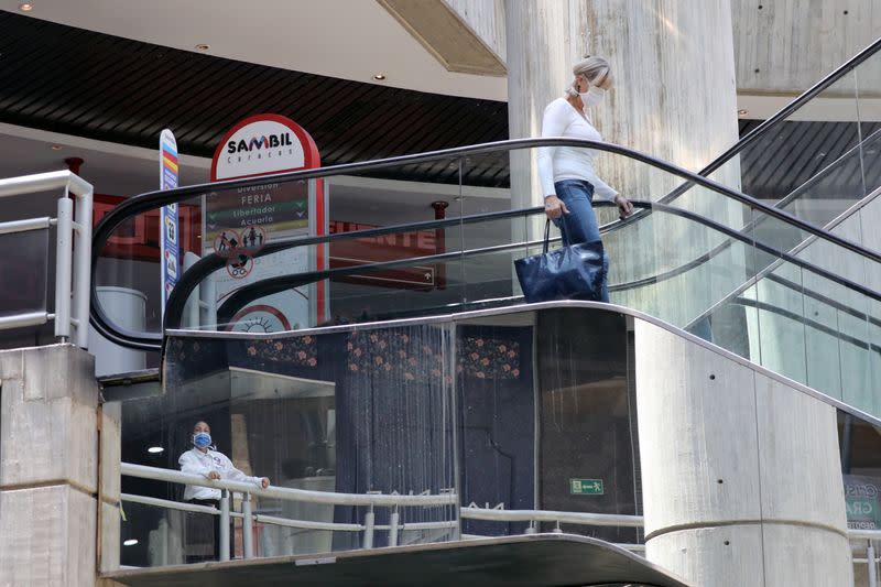 People wearing protective masks walks in a mall during the quarantine in response to the spreading of coronavirus disease (COVID-19) in Caracas