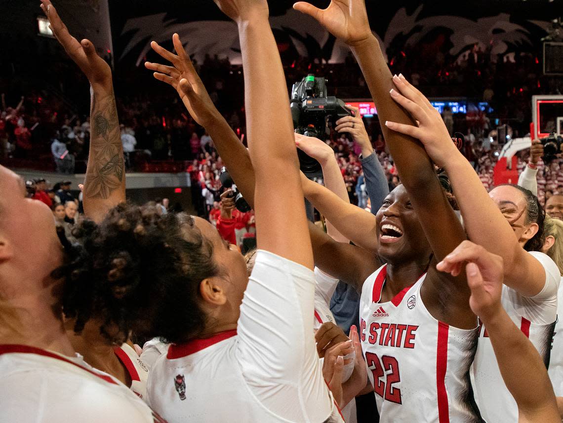 N.C. State’s Saniya Rivers celebrates with teammates after the Wolfpack defeated UConn 92-81 on Sunday, Nov. 12, 2023, at Reynolds Coliseum in Raleigh, N.C. Kaitlin McKeown/kmckeown@newsobserver.com