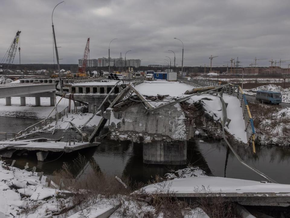 A bus drives past a destroyed bridge in Irpin, outside Kyiv, earlier this month. Feb.  24 will mark one year since Russia's large-scale invasion of Ukraine.  (Roman Pilipey/Getty Images - image credit)