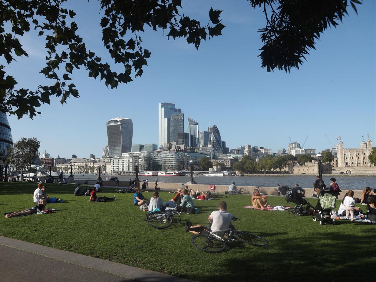 People enjoying the warm weather in Potters Fields Park, London. (Yui Mok/PA)