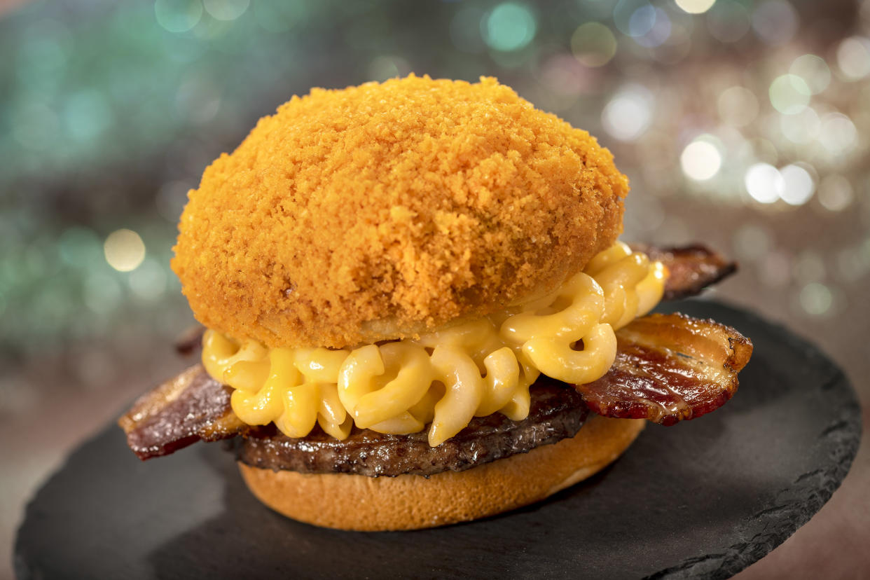 Mac and cheese and cheese puff dust top this burger, found inside Magic Kingdom Park. (Photo: Walt Disney World Resort)