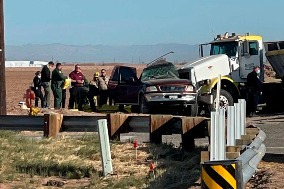 Law enforcement authorities work at the scene of a deadly crash involving a semitruck and an SUV in Holtville, California., on March 2.