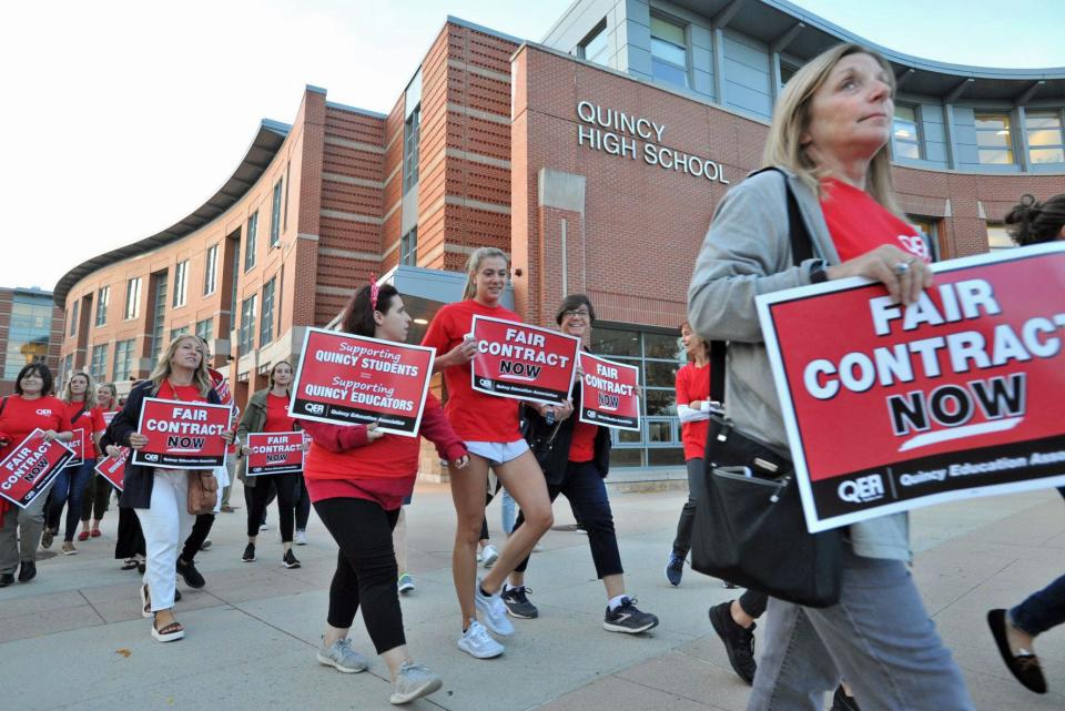 Quincy public school teachers march to the school administration building before the school committee meeting during a rally seeking support for a fair contract Wednesday, Oct. 12, 2022.