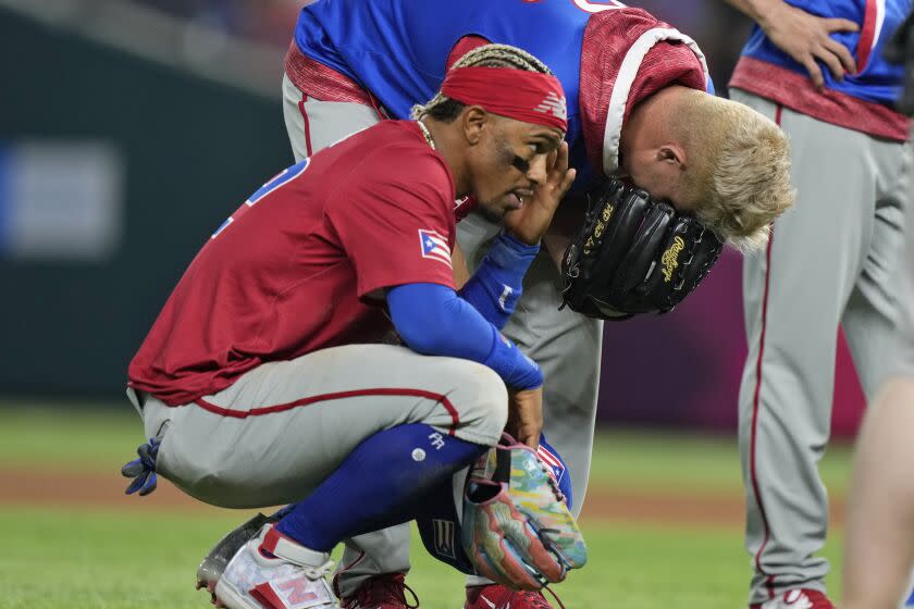 Puerto Rico players react after pitcher Edwin Diaz was injured during a postgame celebration