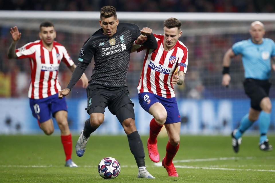 Saul Niguez (right) scored Atletico Madrid's only goal in a 1-0 win over Roberto Firmino and Liverpool. (Photo by Eric Verhoeven/Soccrates/Getty Images)