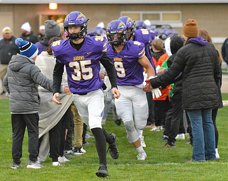 Watertown's Owen Spartz (35) and Austin Johnson run through a group of fans prior to their Eastern South Dakota Conference football game on Friday, Oct. 6, 2023 at Watertown Stadium.