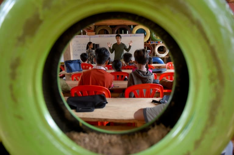 The Coconut School in Cambodia is built almost entirely from waste and features walls made of painted used car tyres